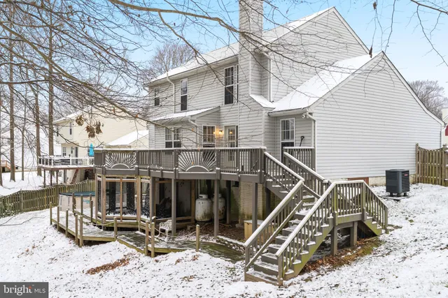 a view of a house with a wooden deck