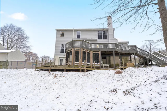 a front view of a house with a yard covered in snow