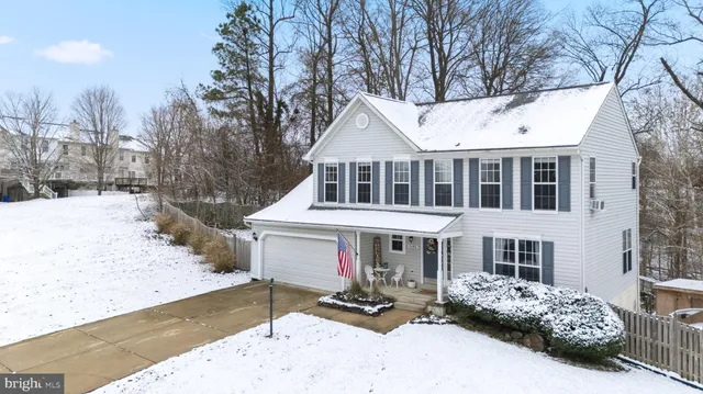 a front view of a house with yard covered in snow