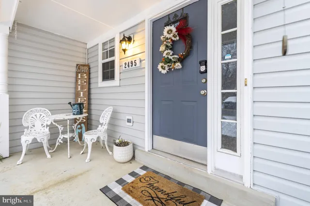 a dining room with furniture and a rug