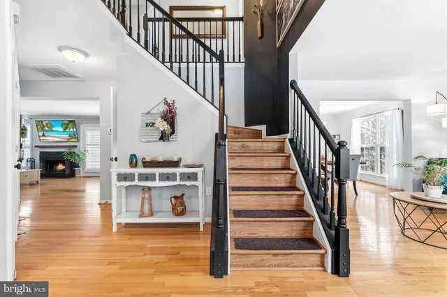 a view of entryway and hall with wooden floor