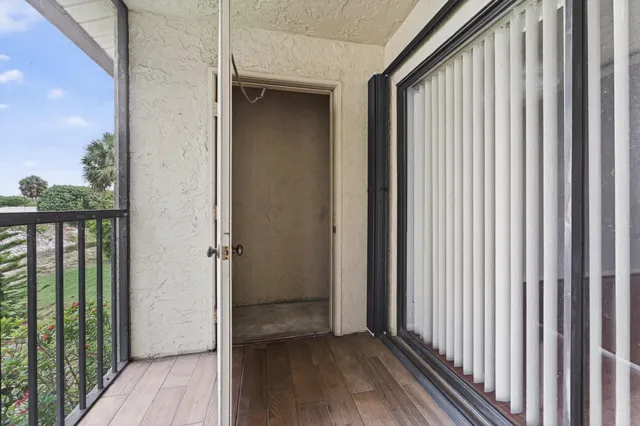 a view of a balcony with wooden floor