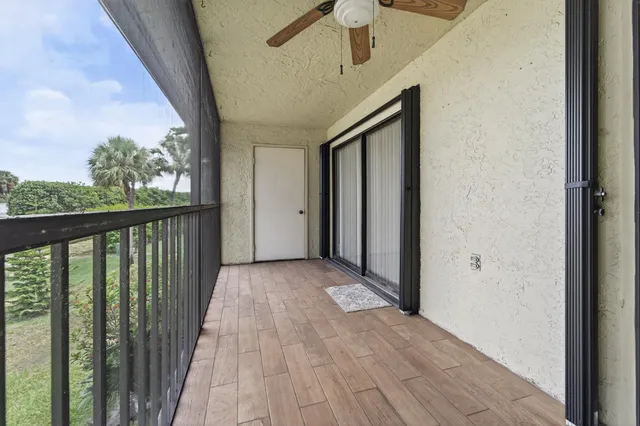 a view of balcony with wooden floor