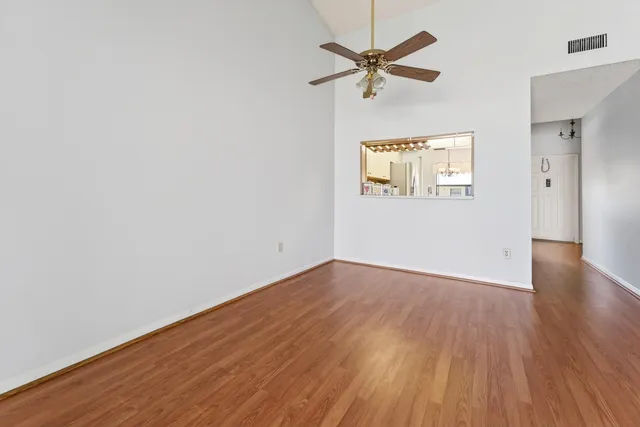 a view of an empty room with wooden floor