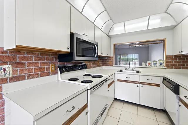 a kitchen with a sink stove and microwave