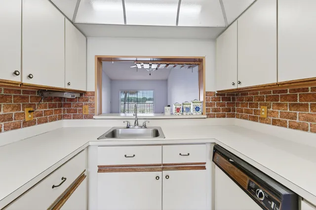 a kitchen with a sink and cabinets