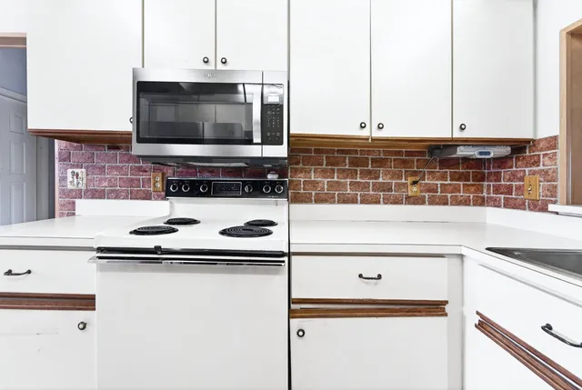 a kitchen with a stove and a microwave