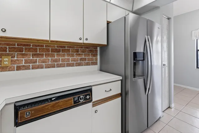 a kitchen with appliances and a refrigerator