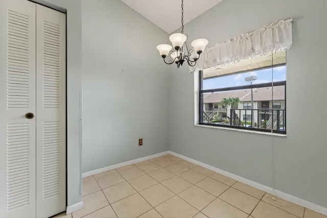 a view of a bedroom with a large window and chandelier