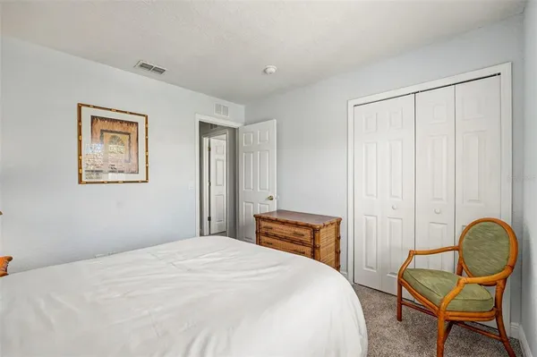 a bedroom with a bed and chair