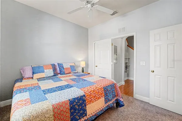 a bedroom with a bed and a chandelier