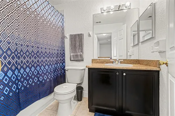 a bathroom with a sink a toilet a mirror and shower