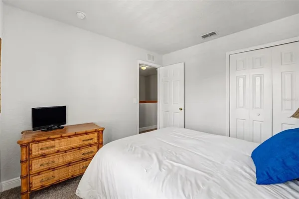 a bedroom with a bed and flat screen tv