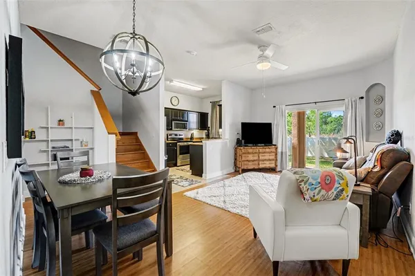 a living room with furniture a flat screen tv and a table