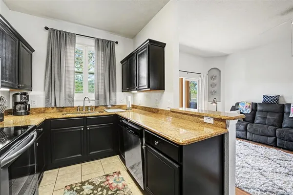 a kitchen with a sink stove and cabinets
