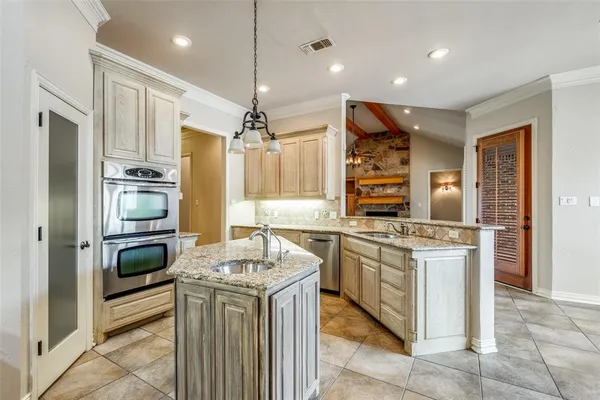 a kitchen with stainless steel appliances granite countertop a stove and a refrigerator