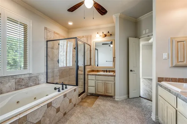 a spacious bathroom with a tub sink shower and mirror