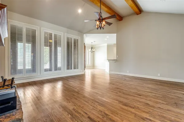 a view of a livingroom with wooden floor and a window