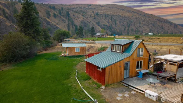 an aerial view of a house with a yard table and chairs