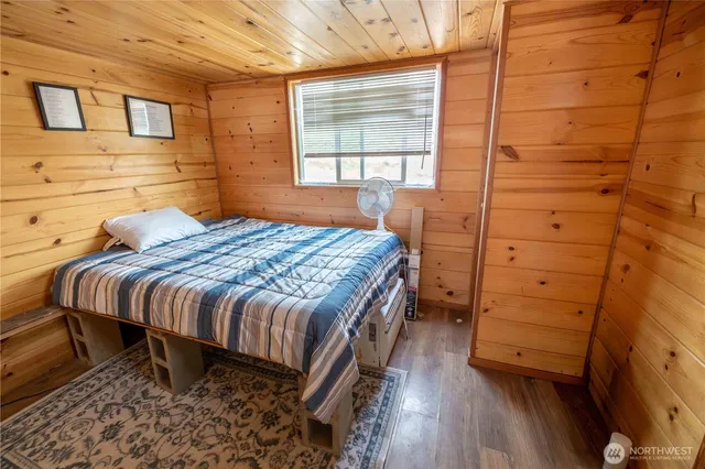 a bed sitting in a bedroom next to a window