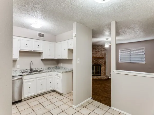 a kitchen with a stove a sink and a refrigerator