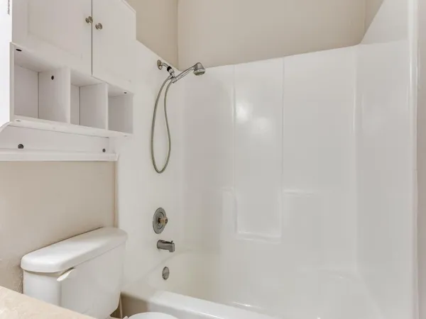 a bathroom with a shower a toilet and a shower