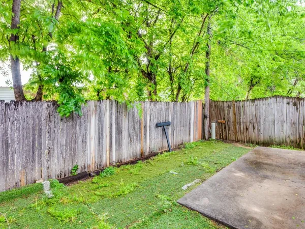 a view of an outdoor space with wooden fence