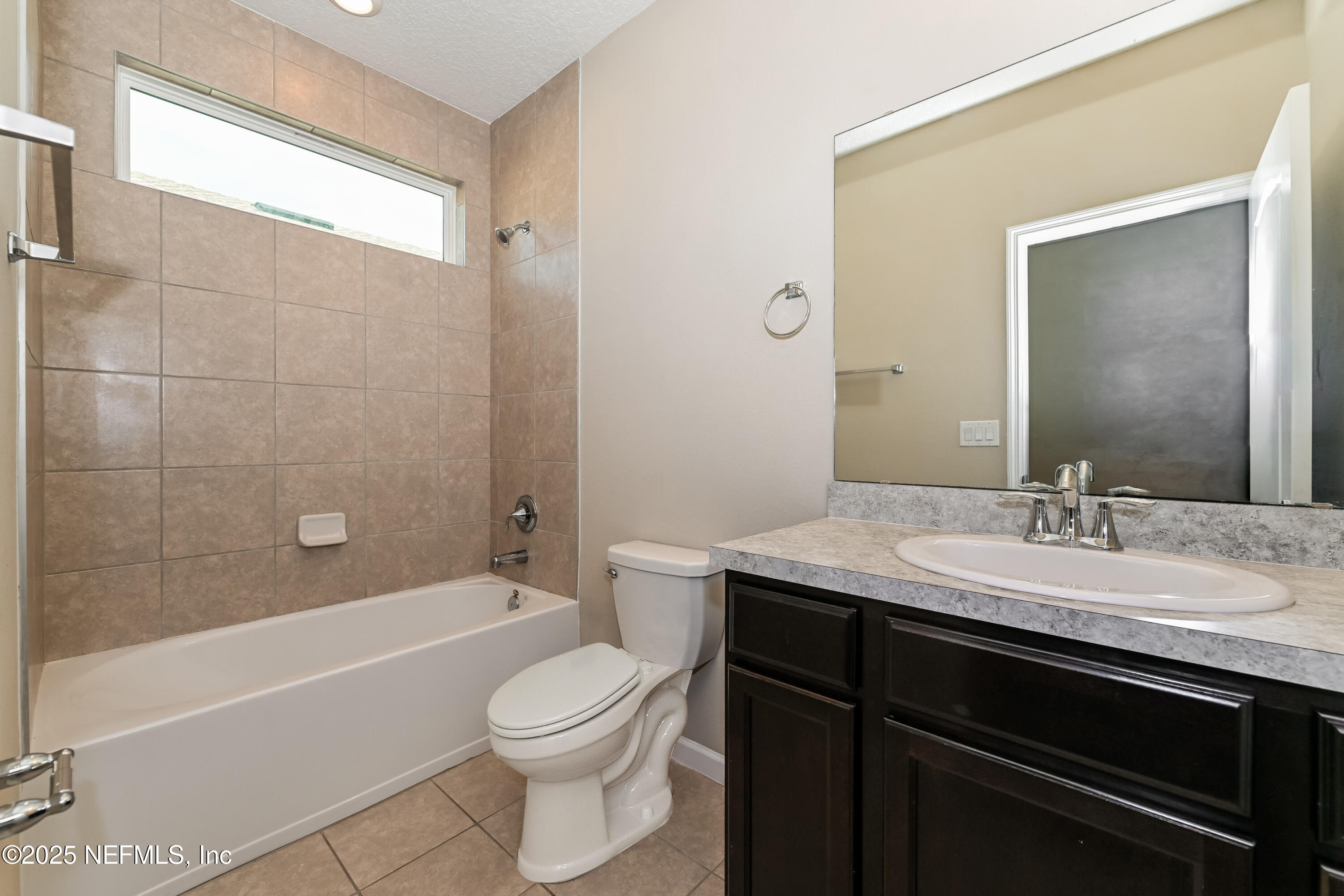 203 Stone Arbor Lane St. Augustine, FL 32086 - Photo 14 of 15 a bathroom with a granite countertop sink toilet a mirror and bathtub