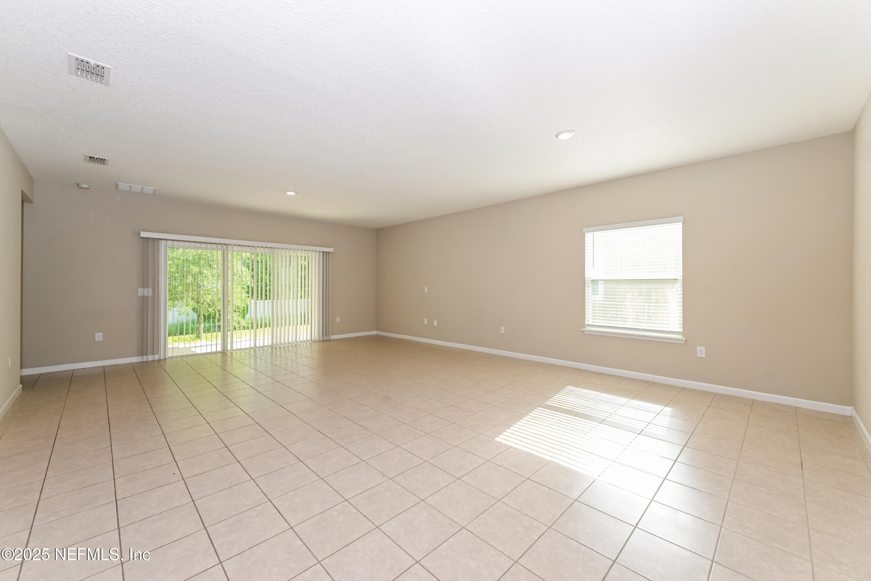 203 Stone Arbor Lane St. Augustine, FL 32086 - Photo 2 of 15 a view of an empty room with a window