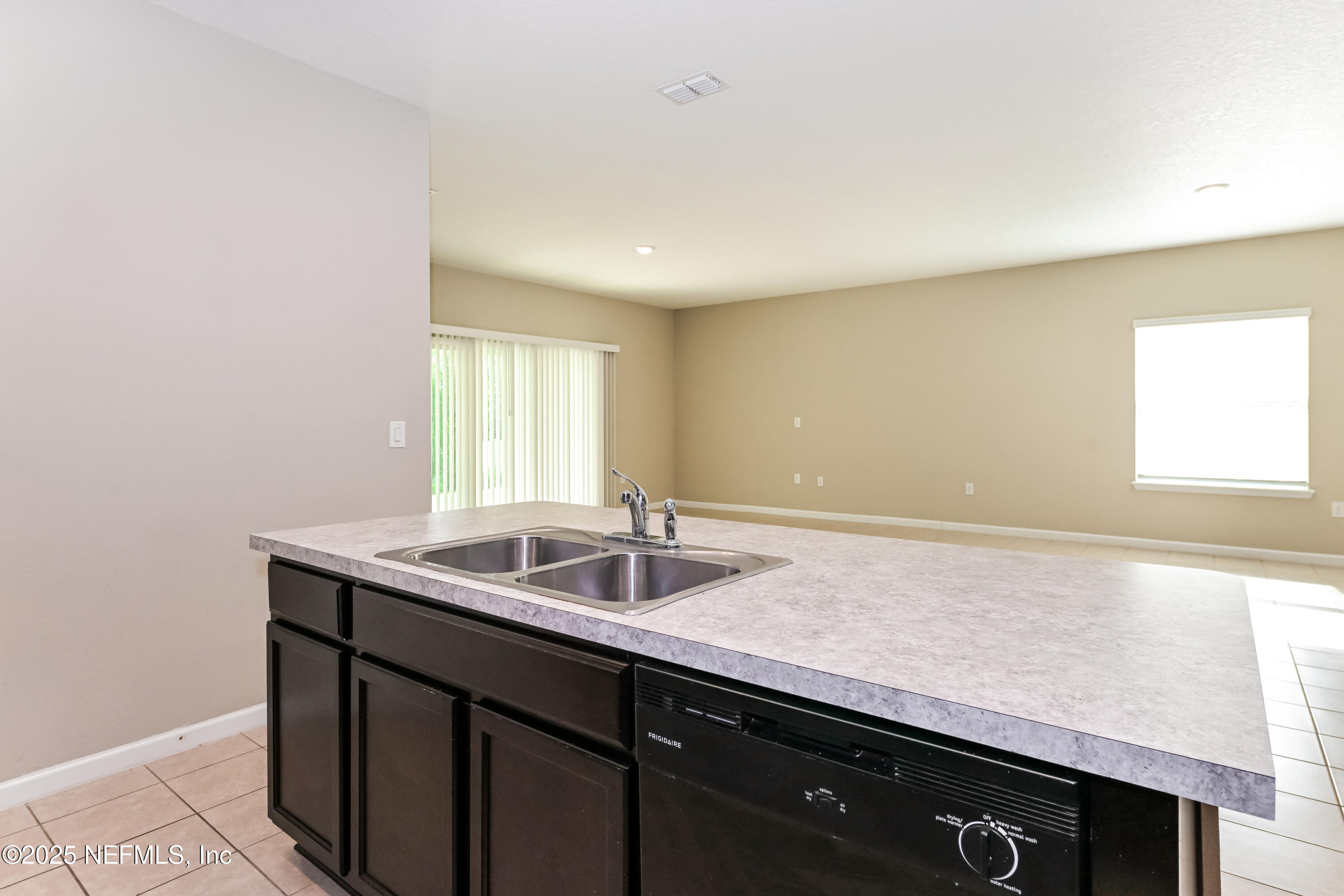 203 Stone Arbor Lane St. Augustine, FL 32086 - Photo 7 of 15 a kitchen with granite countertop a sink and a window