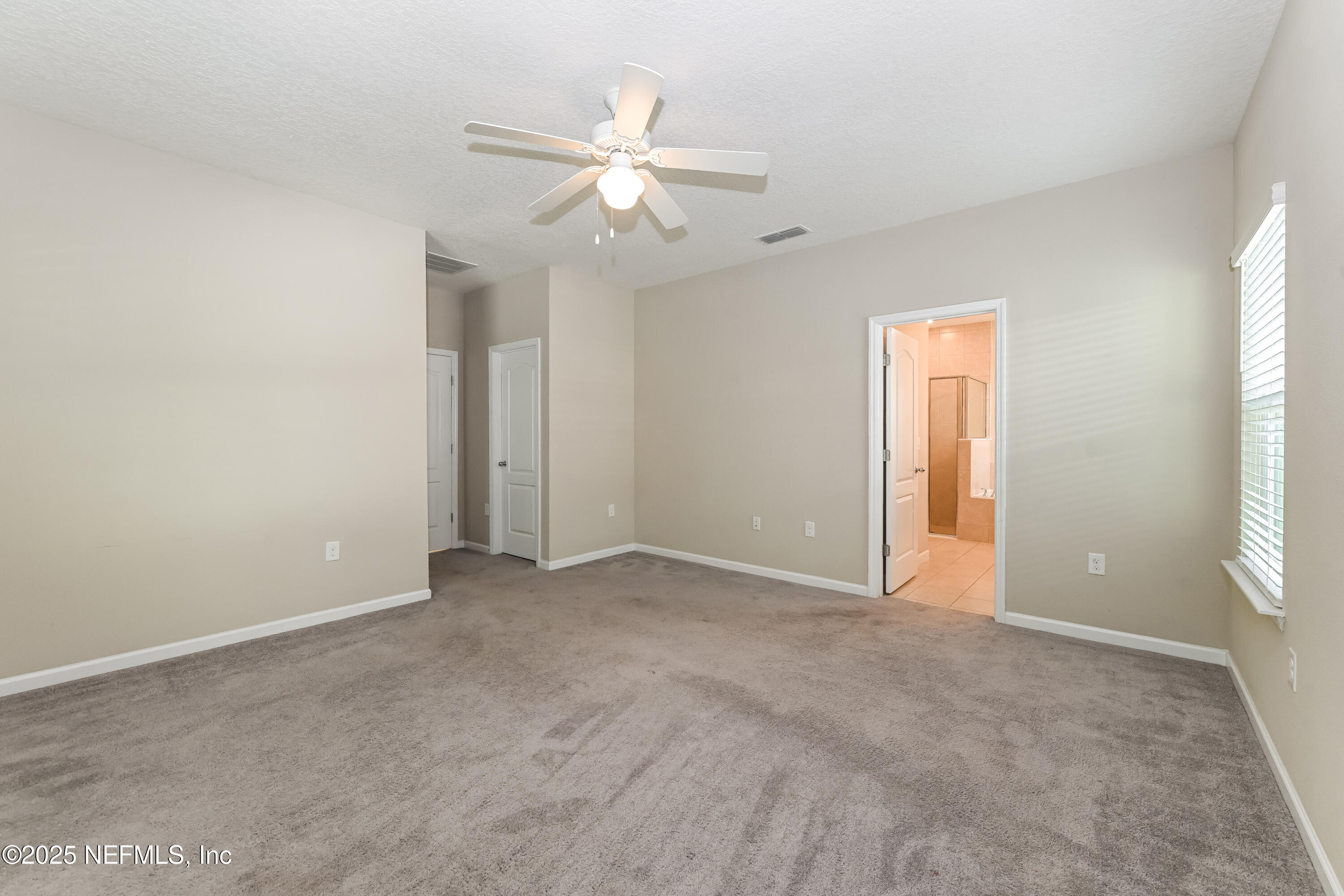 203 Stone Arbor Lane St. Augustine, FL 32086 - Photo 9 of 15 an empty room with windows and fan
