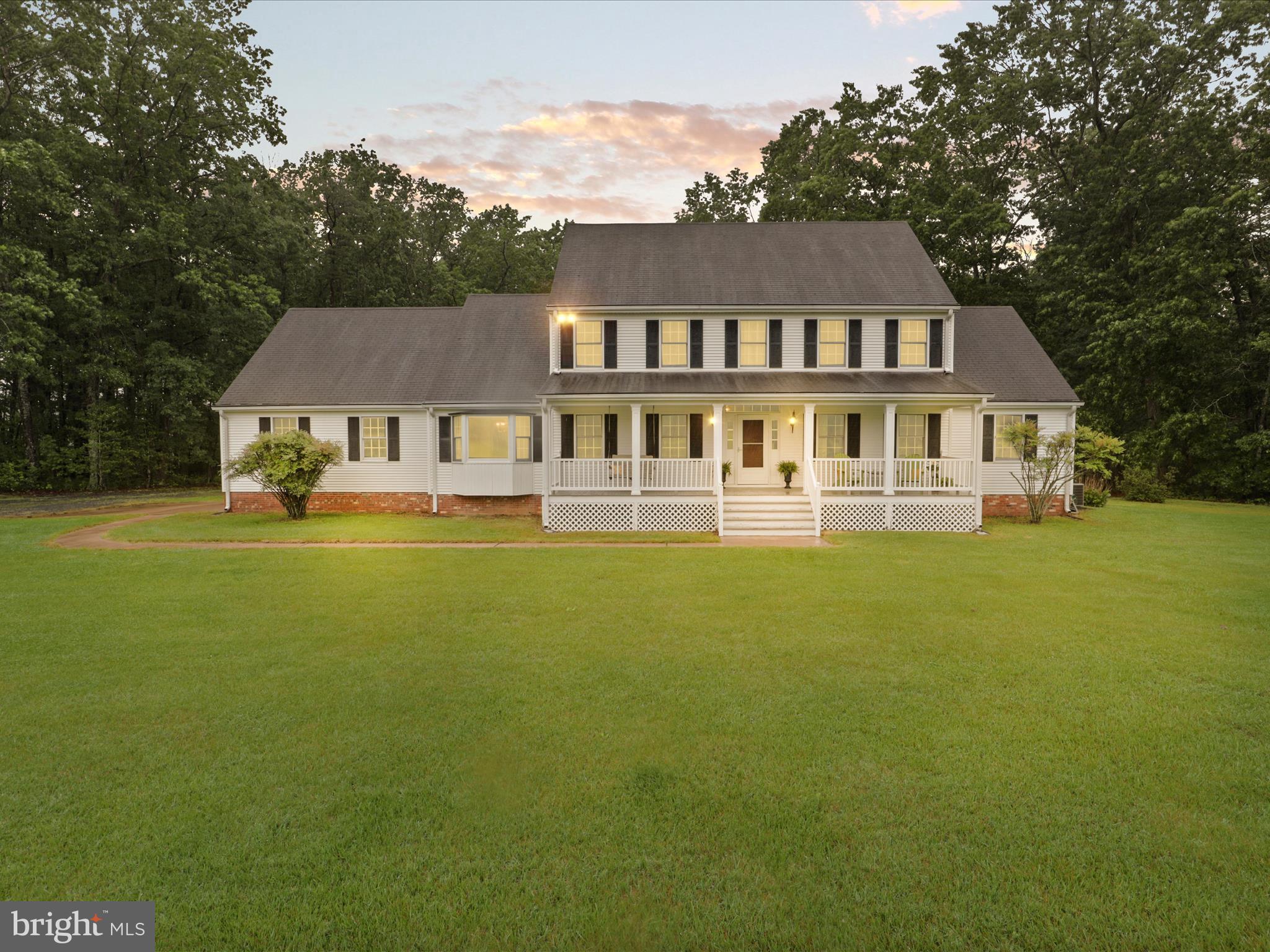 a front view of a house with swimming pool and porch