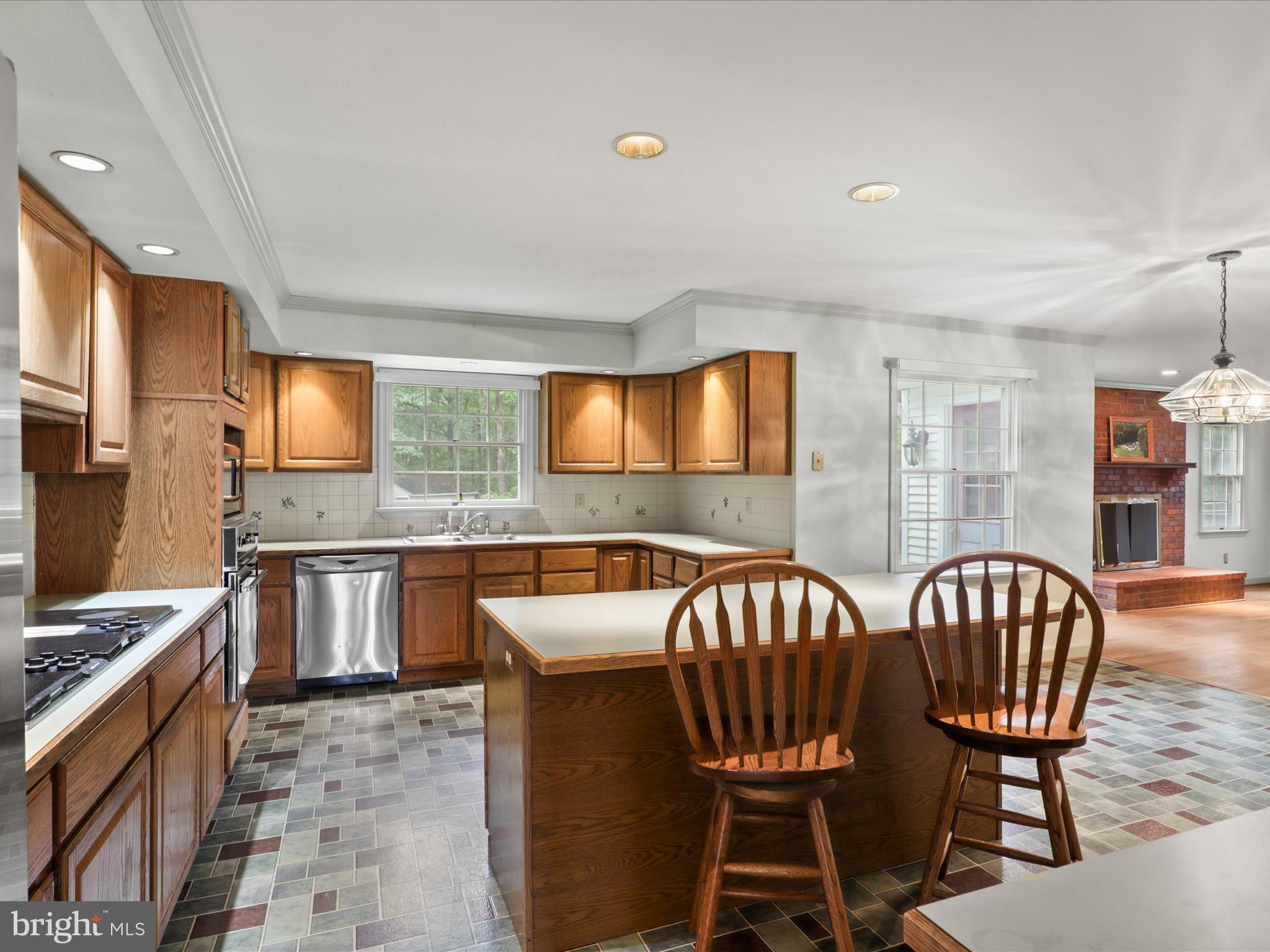 13124 South River Road Sumerduck, VA 22742 - Photo 11 of 54 a kitchen with a table chairs microwave and refrigerator