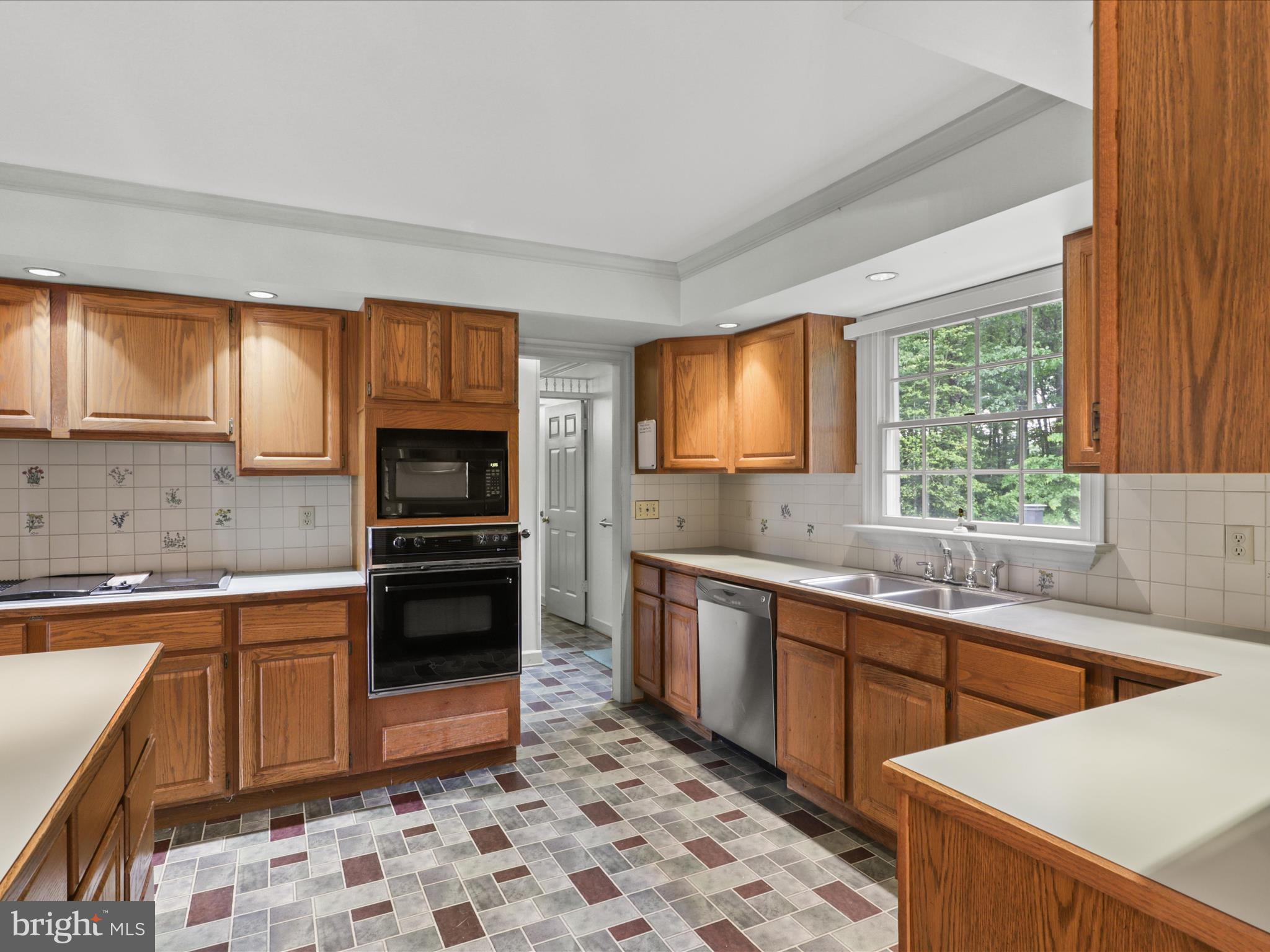 13124 South River Road Sumerduck, VA 22742 - Photo 14 of 54 a kitchen with stainless steel appliances a stove sink microwave and cabinets