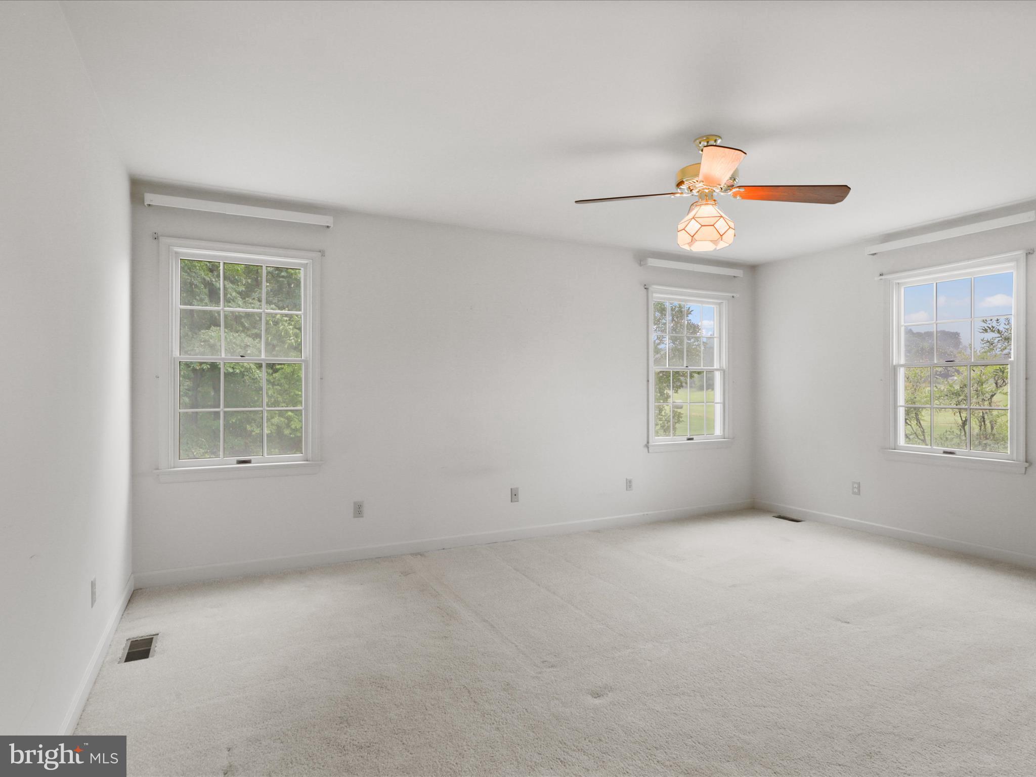 13124 South River Road Sumerduck, VA 22742 - Photo 21 of 54 an empty room with windows and chandelier fan