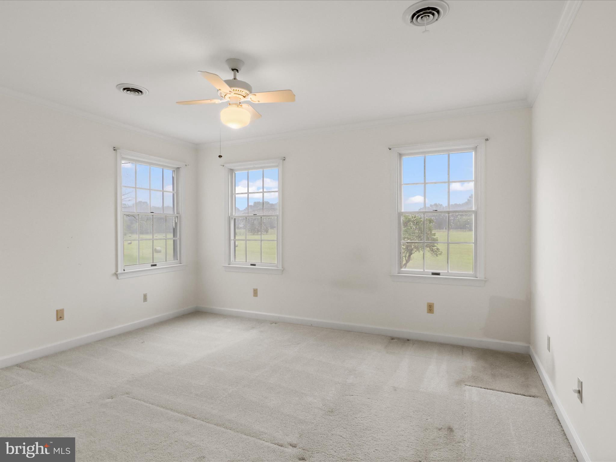 13124 South River Road Sumerduck, VA 22742 - Photo 30 of 54 an empty room with a window and a fan
