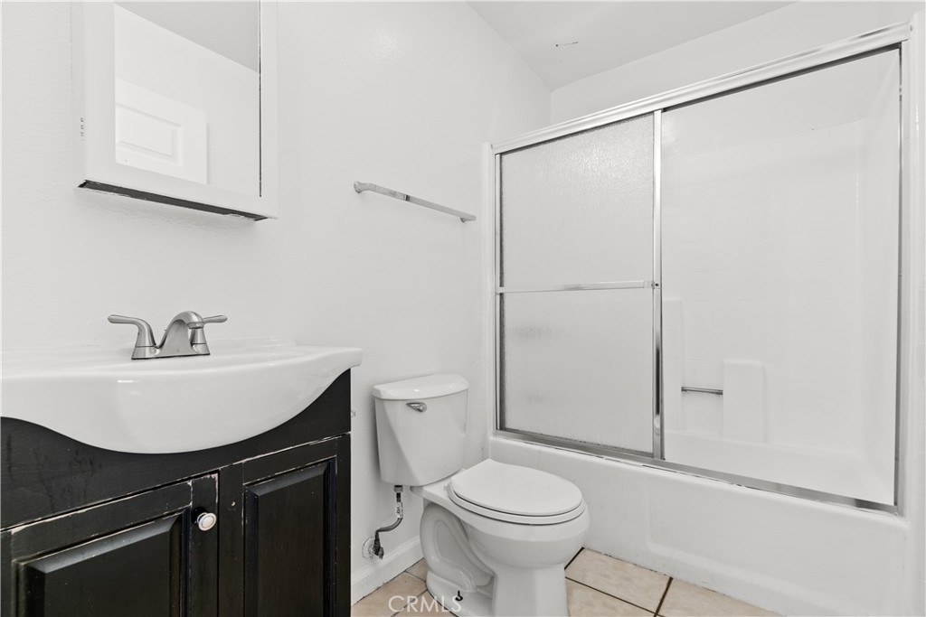 5915 Woodman Avenue, Unit 103 Van Nuys, CA 91401 - Photo 5 of 9 a bathroom with a sink toilet and vanity