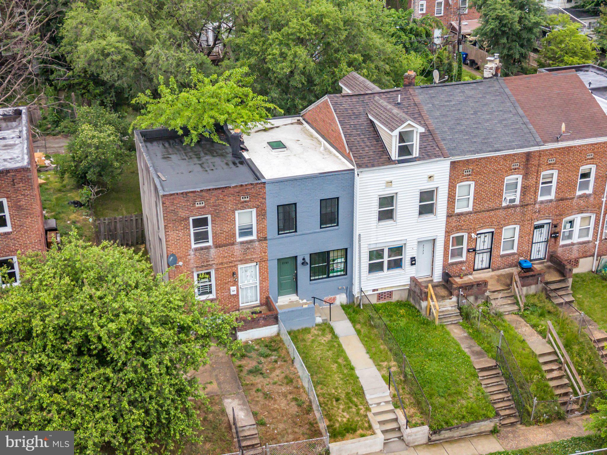 2731 Round Road Baltimore, MD 21225 - Photo 15 of 26 Charming row homes with lush greenery.