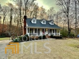 579 Wesley Circle Toccoa, GA 30577 - Photo 1 of 1 a front view of a house with a garden and porch