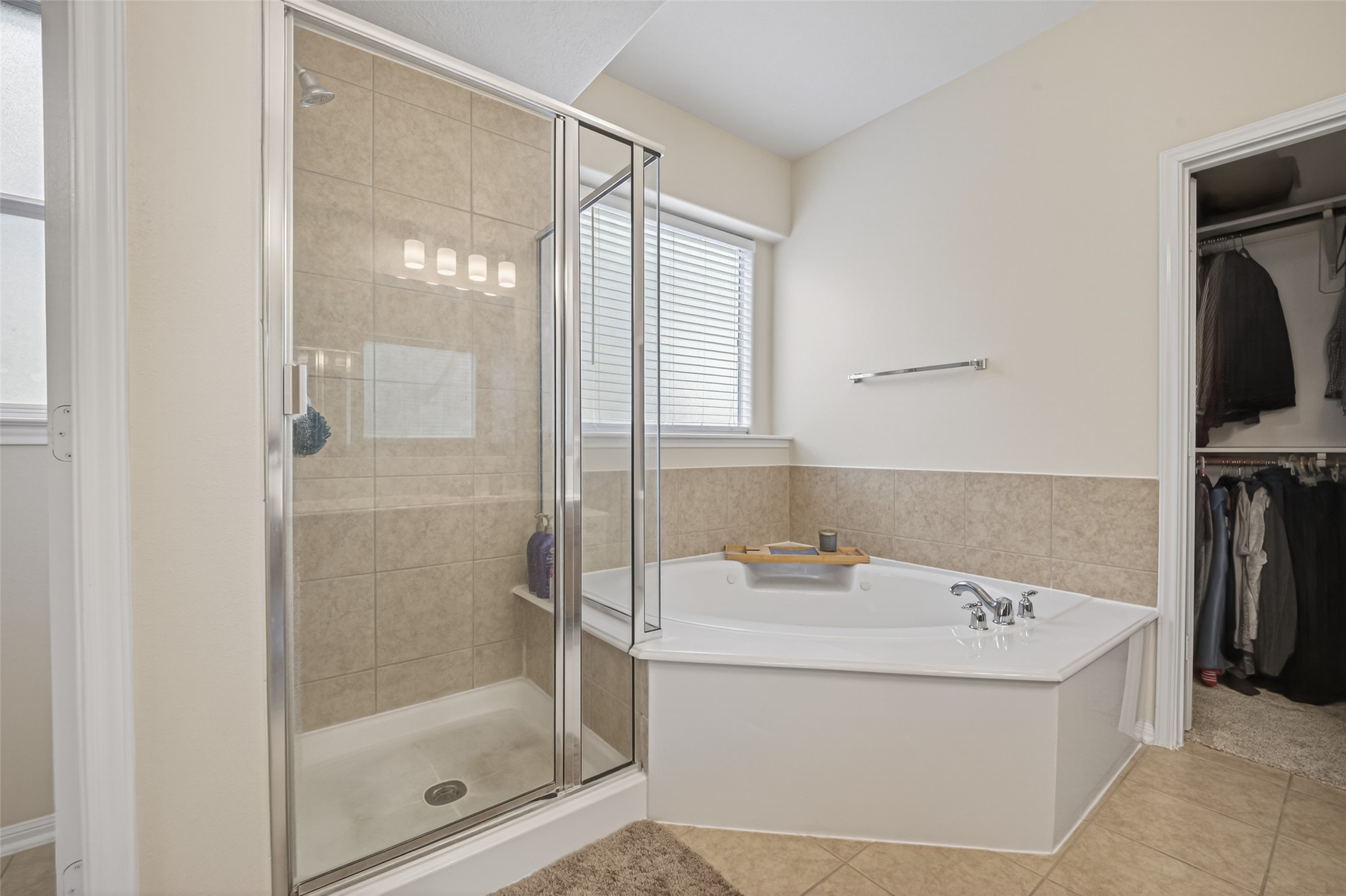 3219 Legends Mist Drive Spring, TX 77386 - Photo 22 of 37 a bathroom with a tub sink and mirror