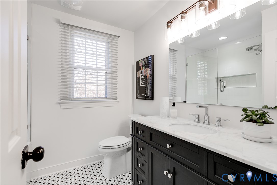 3150 East Brigstock Road Midlothian, VA 23113 - Photo 39 of 50 a bathroom with a sink a toilet and a mirror