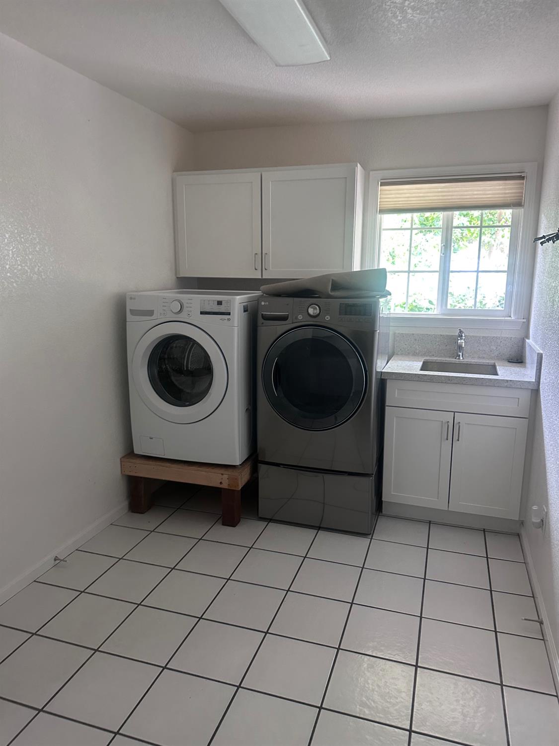 7124 Ospital Road Valley Springs, CA 95252 - Photo 11 of 37 a utility room with cabinets washer and dryer