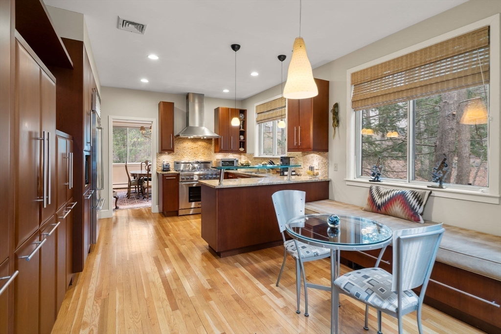 214 Allandale Road, Unit D Boston, MA 02467 - Photo 14 of 40 a living room with stainless steel appliances granite countertop furniture wooden floor and a large window