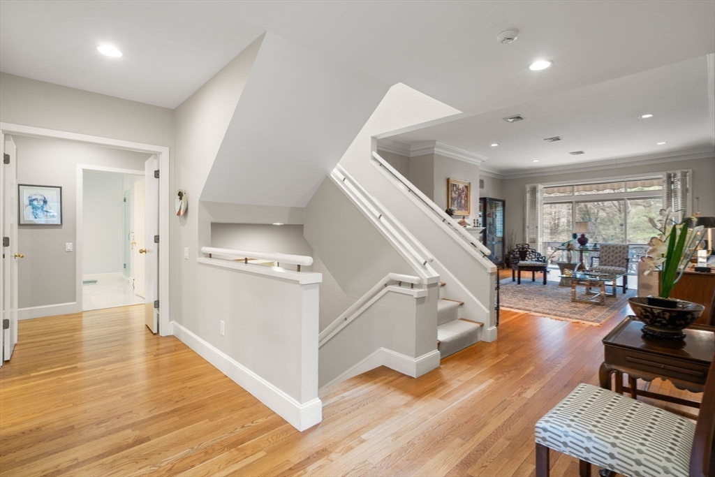 214 Allandale Road, Unit D Boston, MA 02467 - Photo 24 of 40 a living room with furniture and a wooden floor