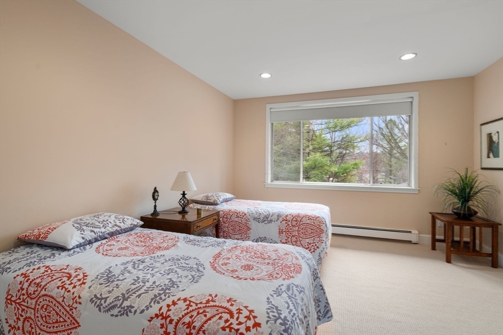 214 Allandale Road, Unit D Boston, MA 02467 - Photo 28 of 40 a bedroom with a large bed and a window