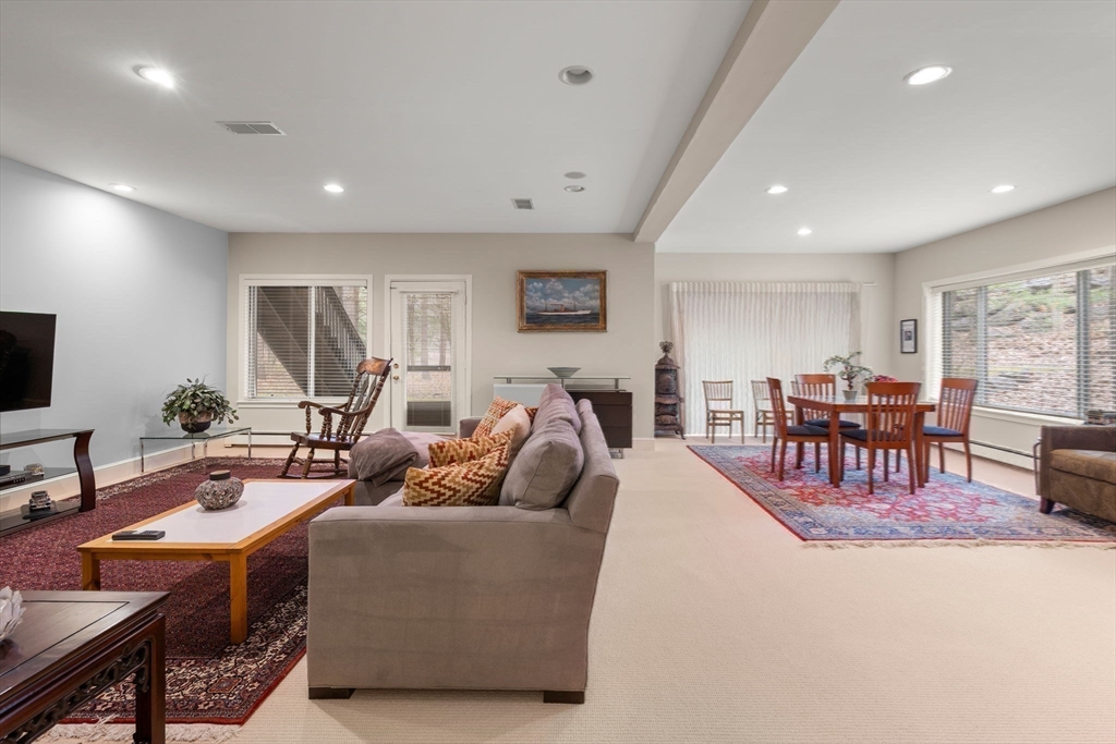 214 Allandale Road, Unit D Boston, MA 02467 - Photo 32 of 40 a living room with furniture and a flat screen tv
