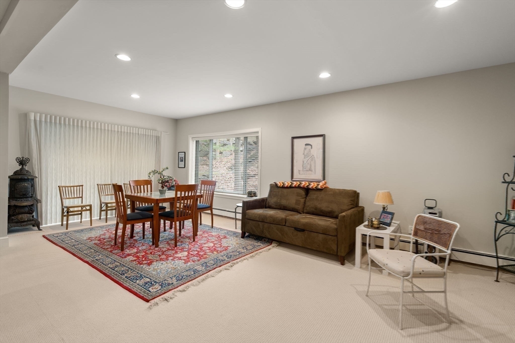 214 Allandale Road, Unit D Boston, MA 02467 - Photo 33 of 40 a living room with furniture and a dining table