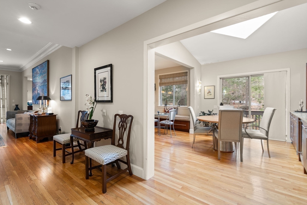 214 Allandale Road, Unit D Boston, MA 02467 - Photo 4 of 40 a living room with furniture a table and a large window