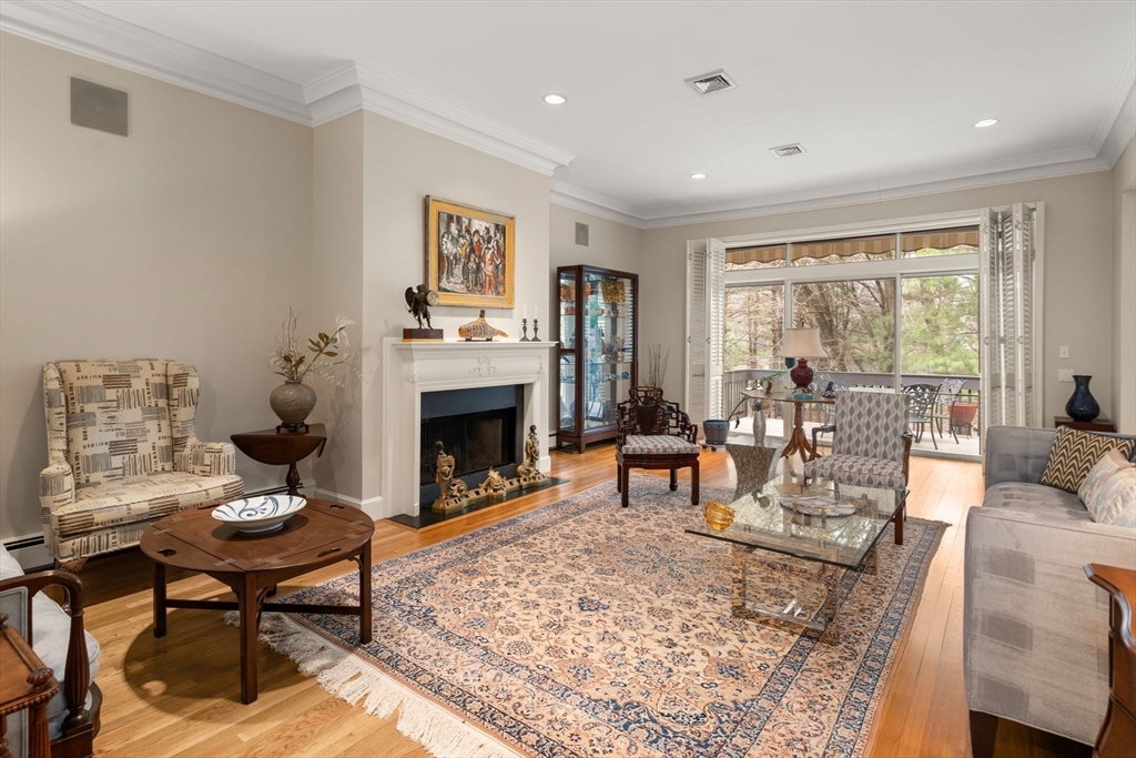 214 Allandale Road, Unit D Boston, MA 02467 - Photo 5 of 40 a living room with furniture and a fireplace