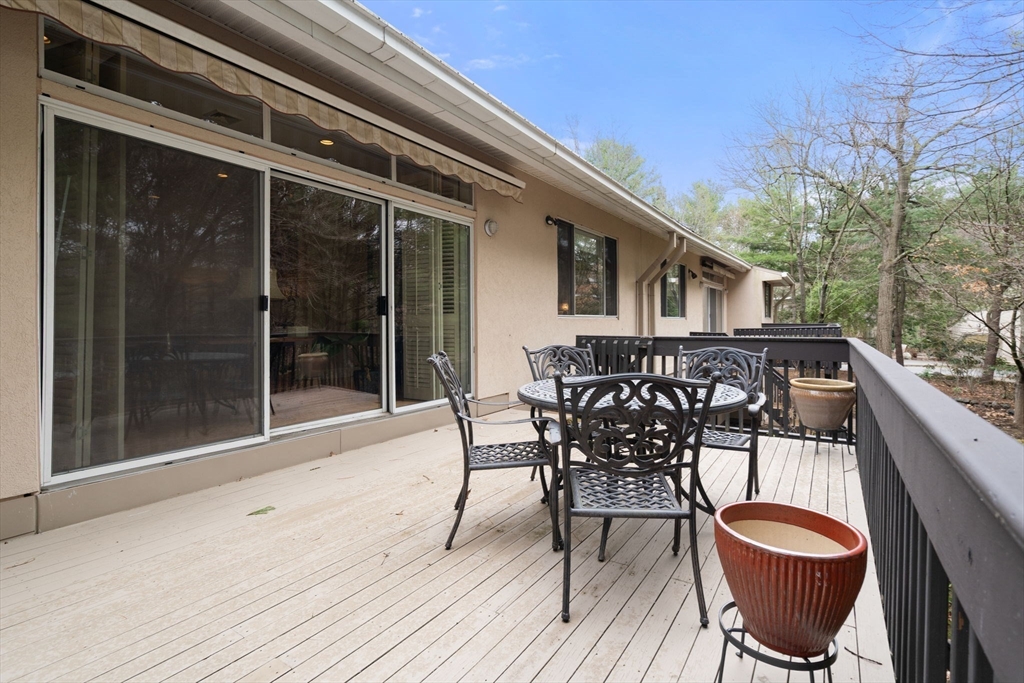 214 Allandale Road, Unit D Boston, MA 02467 - Photo 9 of 40 a patio with wooden floor and outdoor seating